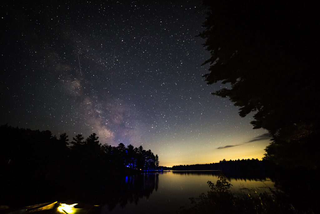 Caption for the photo: Milky Way Rising over Wolf Lake Nikon D810, Laowa 12mm f/2.8 | ISO400, 20 sec @ f/2.8