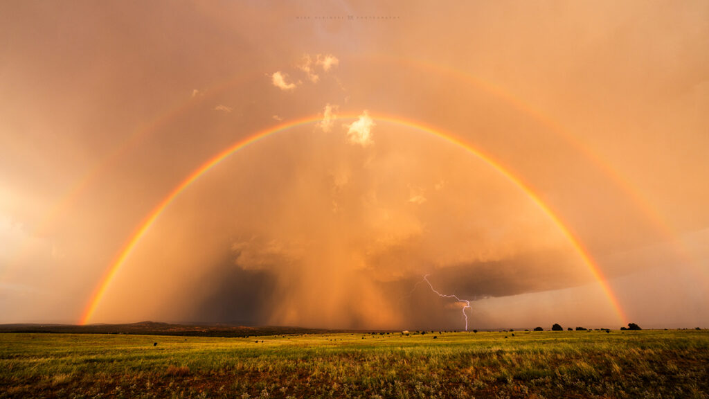 A double rainbow hangs over Ash Fork, Arizona, as a strong storm drops rain, hail and lightning over the the town.